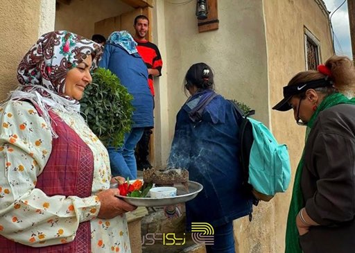 خانمی روستایی با اسفند به استقبال گروهی از همسفران زیواتور آمده